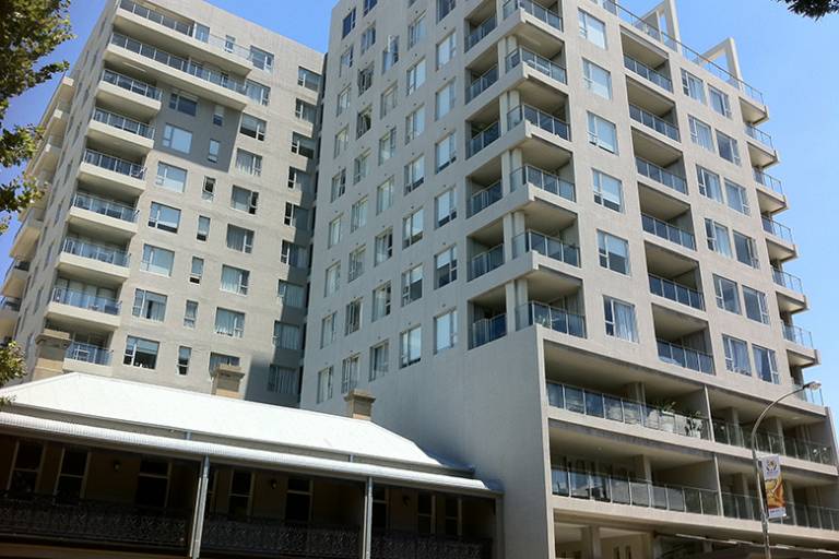 Exterior view of Newcastle Central Plaza Apartment Hotel, a high-rise modern building with balconies