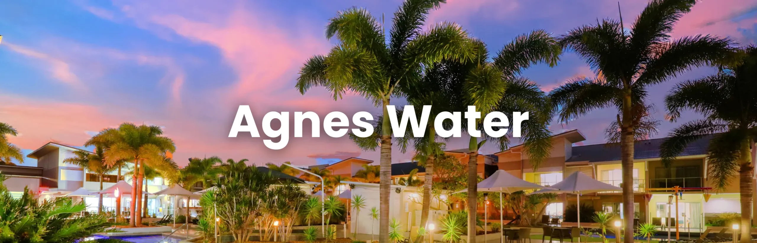 1770 Conference venue at a tropical resort in Agnes Water, featuring palm trees, a poolside area and modern accommodation at sunset.