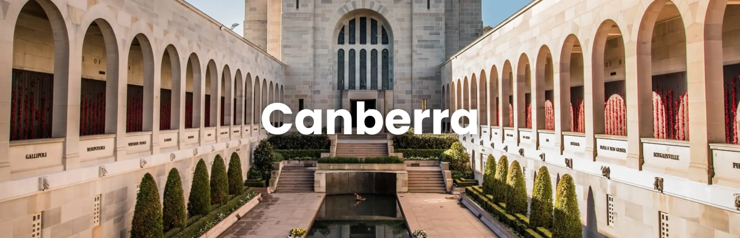 The Australian War Memorial in Canberra with a reflecting pool and arched colonnades, representing the Canberra Conference location.