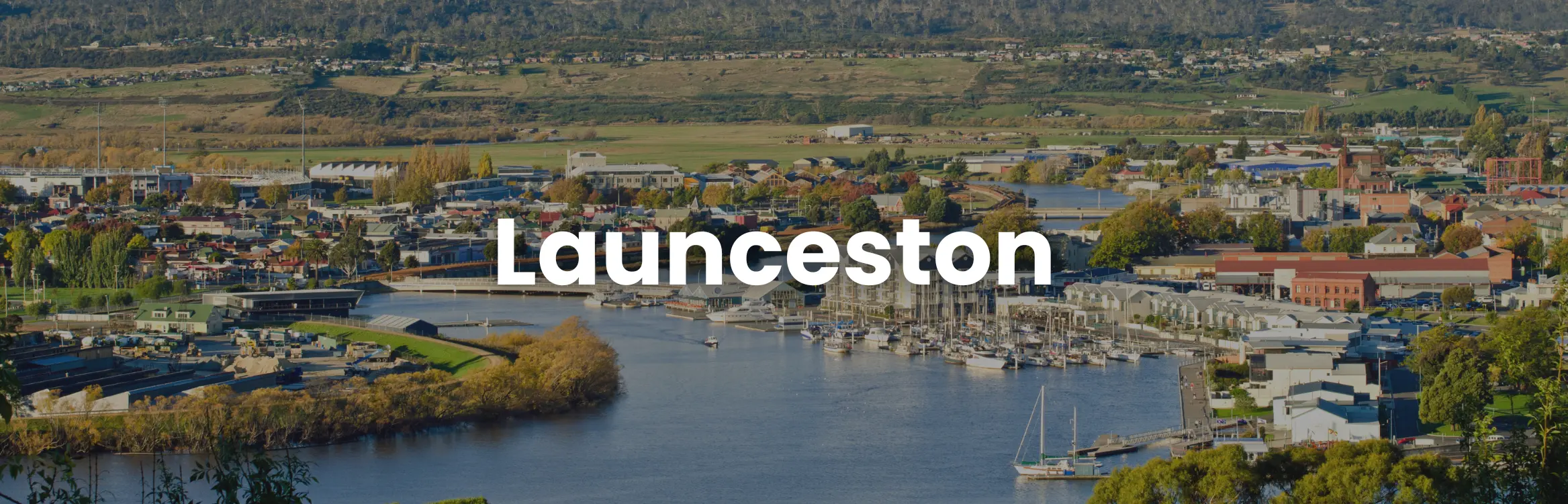 A panoramic view of Launceston’s waterfront and city centre, showcasing Launceston conference venues, marinas and scenic river surrounds in northern Tasmania.